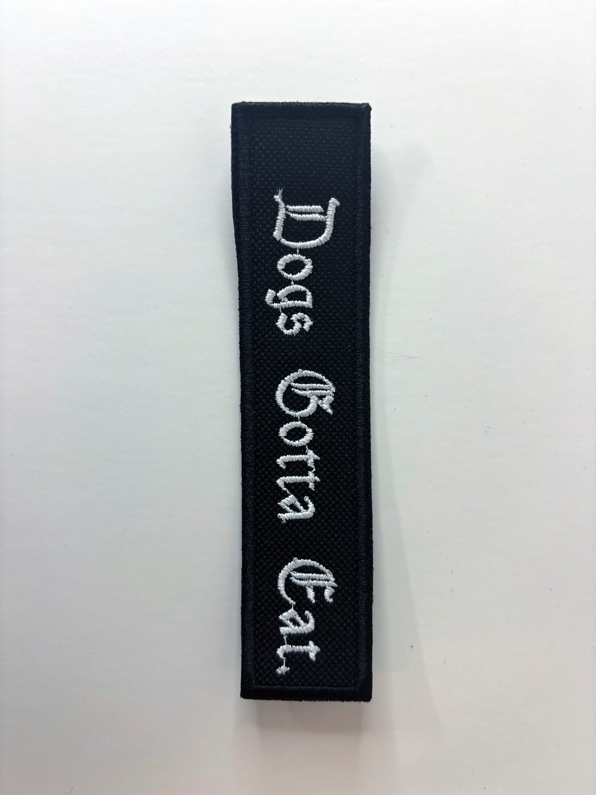 Dogs Gotta Eat. Embroidered Flight Tag