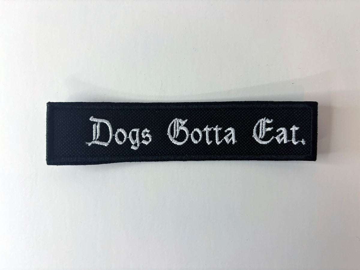 Dogs Gotta Eat. Embroidered Flight Tag
